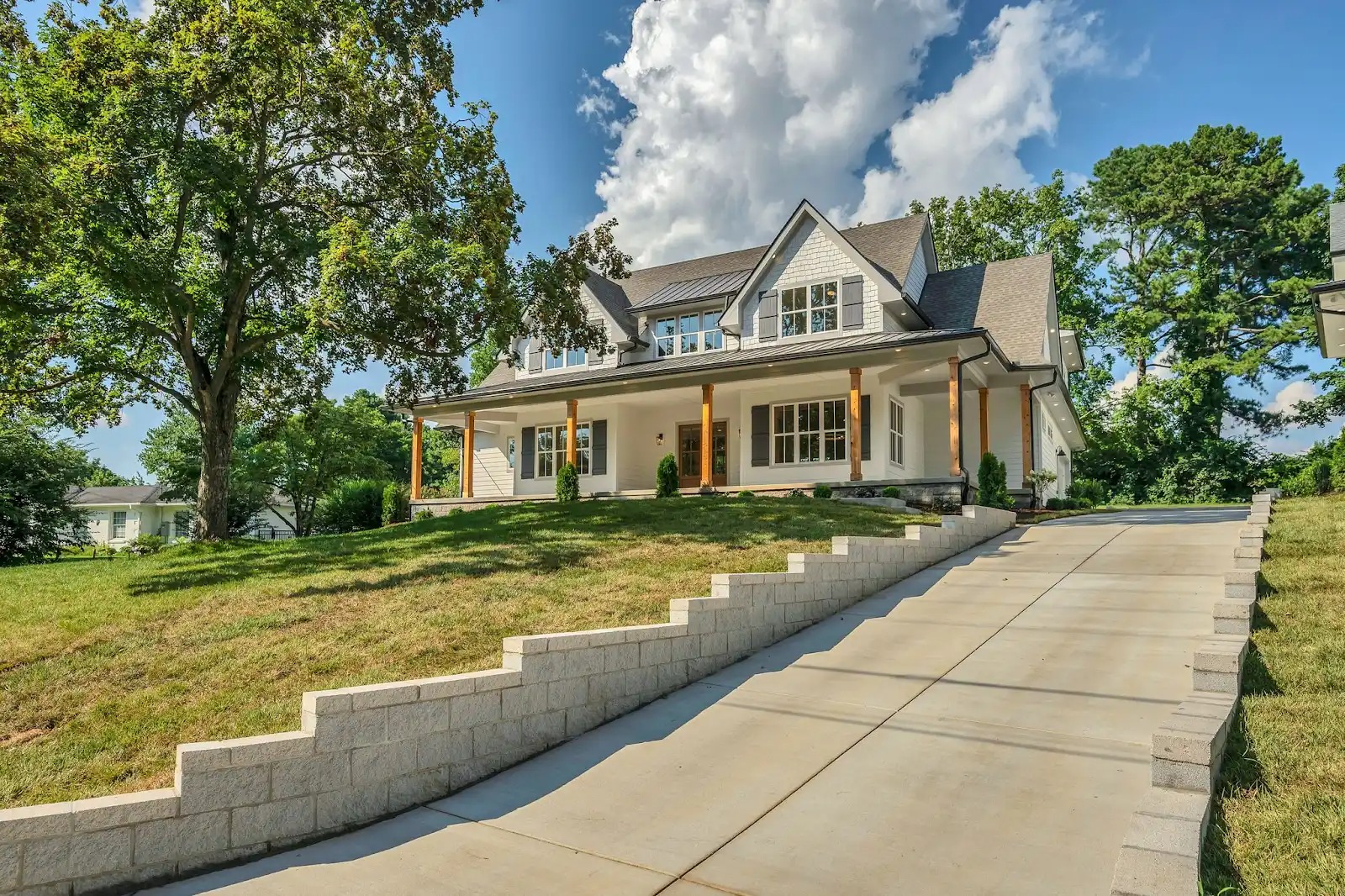 Luxury craftsman-style home in Oak Hill Nashville with stone retaining walls and covered porch